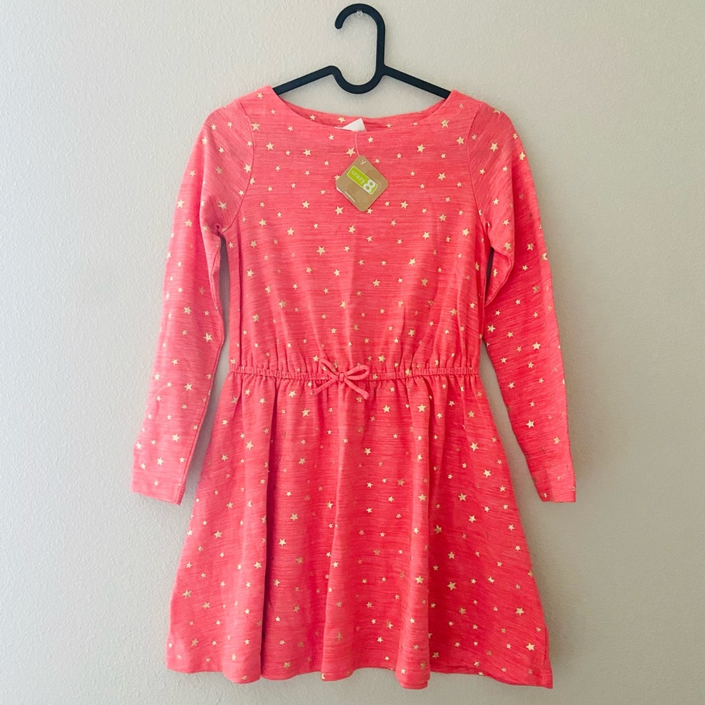 This is a pink dress with bright gold stars.